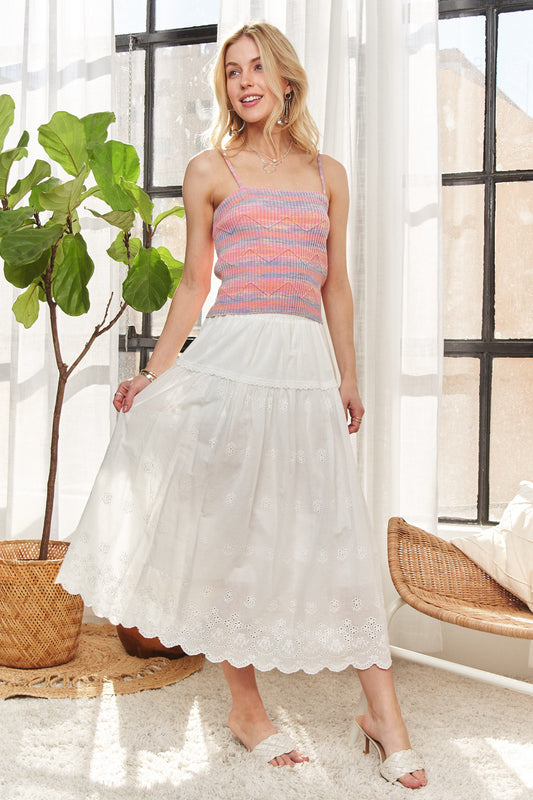 Woman wearing ADORA Zigzag Pattern Stripe Rib Knit Cami paired with a white skirt in a bright room