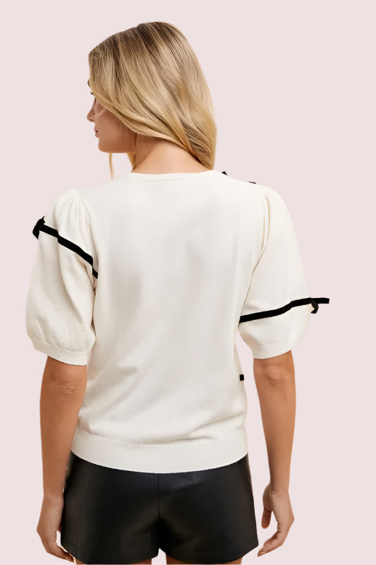 Back view of Annie Wear Striped Bow Round Neck Knit Top featuring puff sleeves and a stylish design