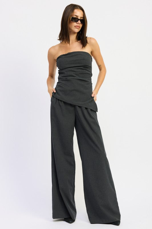 Emory Park Asymmetrical Bustier Tube Top in gray, stylishly paired with wide-leg pants for a chic look