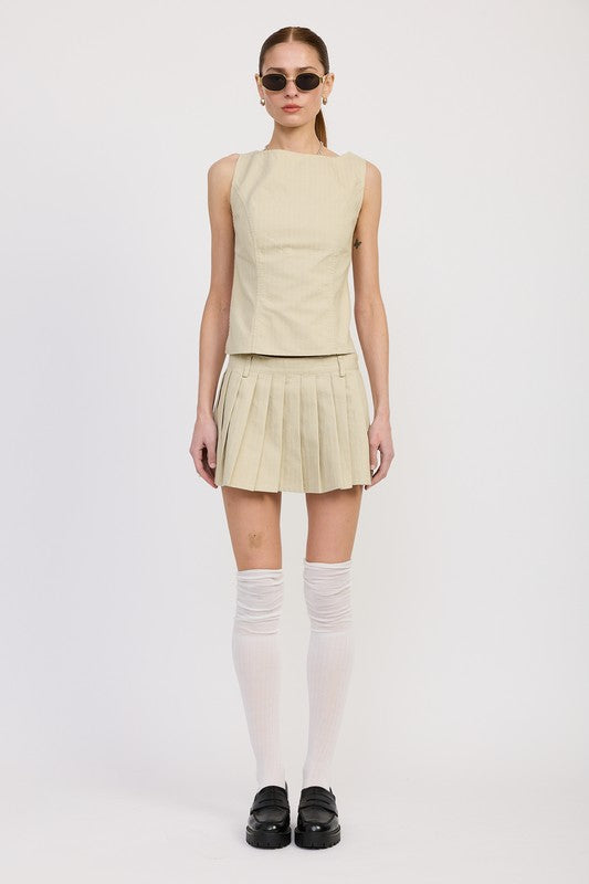 Emory Park beige Backless Rider Top paired with pleated skirt worn with white knee-high socks and black shoes
