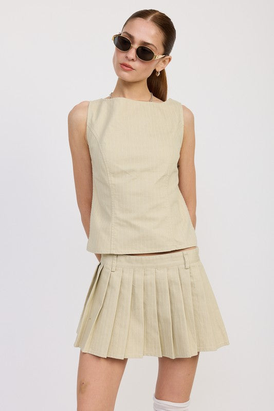 Emory Park beige Backless Rider Top paired with matching pleated skirt and sunglasses