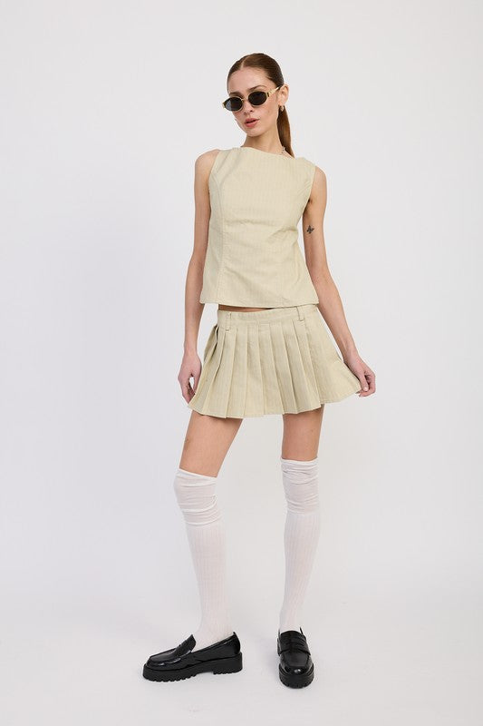 Emory Park Backless Rider Top in beige worn with matching pleated skirt and knee-high socks