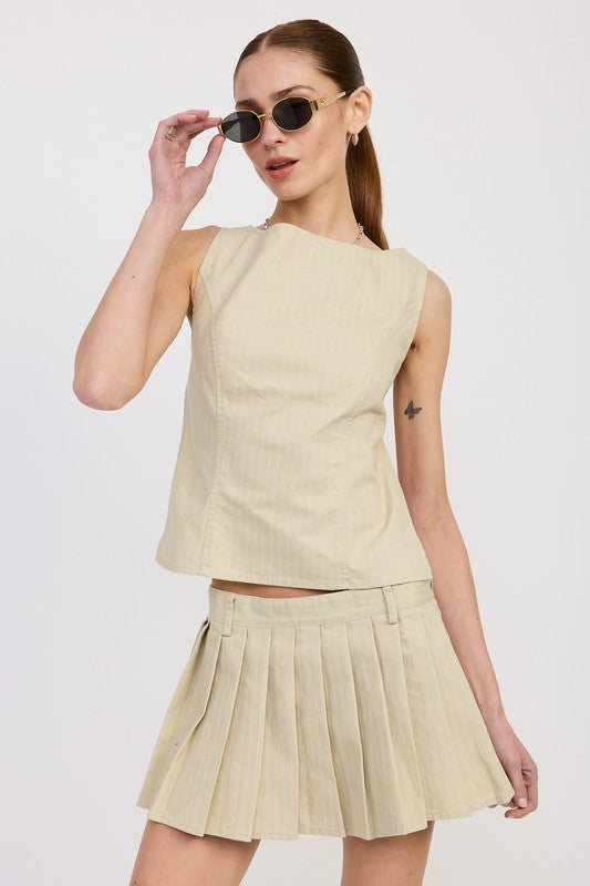Emory Park sleeveless beige Backless Rider Top paired with matching pleated skirt and sunglasses
