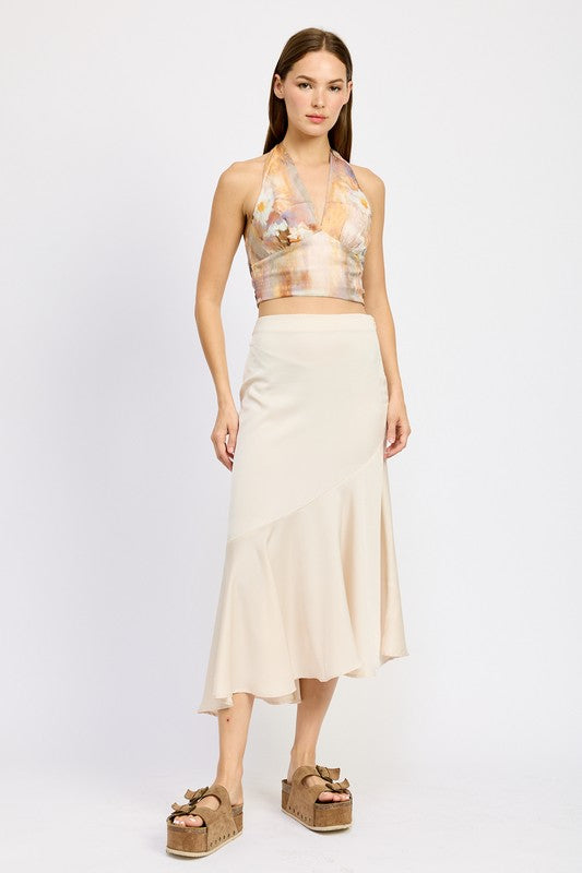 Emory Park asymmetrical ruffle hem skirt in cream worn with a floral halter crop top and wedge sandals