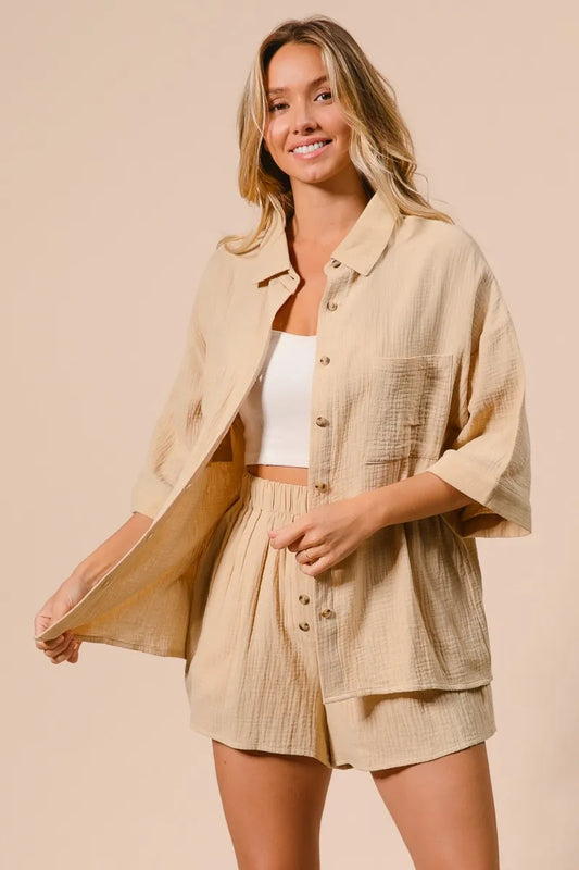 Woman wearing BiBi Crinkle Gauze Shirt and Short Set in beige with button-up shirt and elastic waist shorts