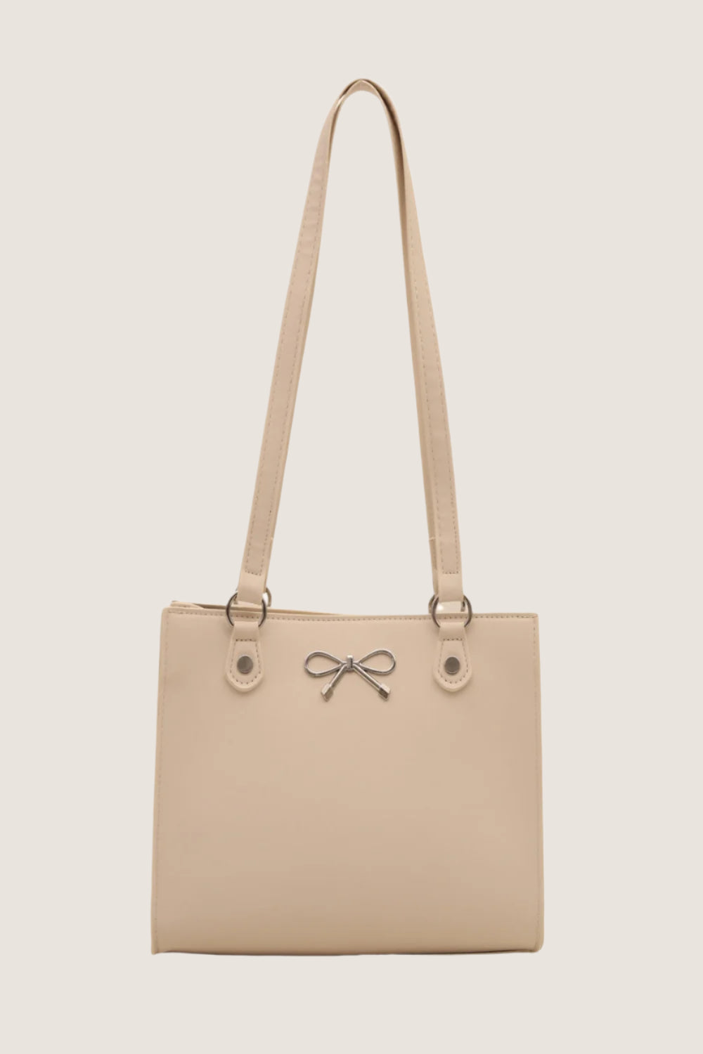 Bow detail shoulder bag in beige with elegant bow accent and adjustable straps