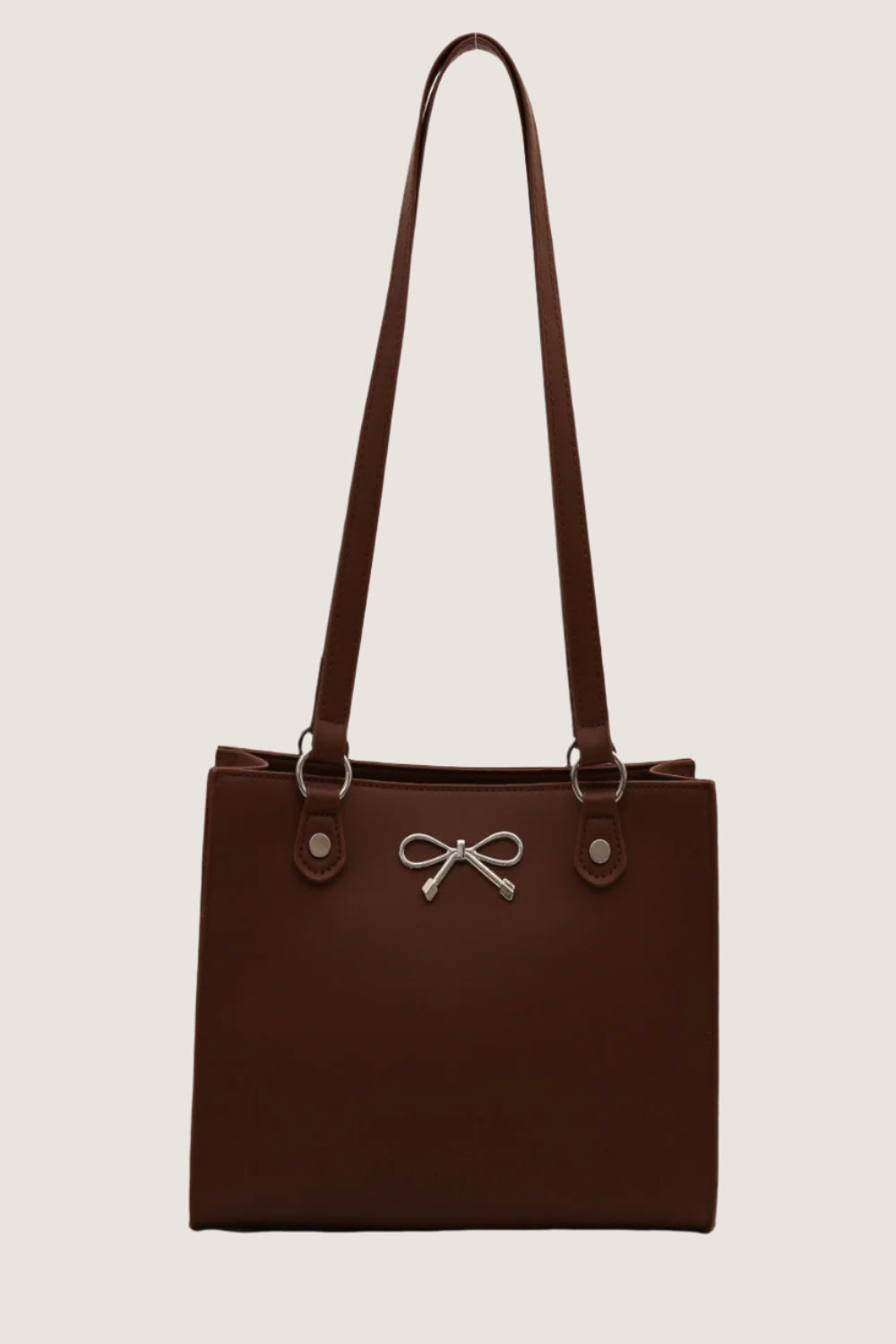 Stylish brown bow detail shoulder bag with adjustable straps and silver accents