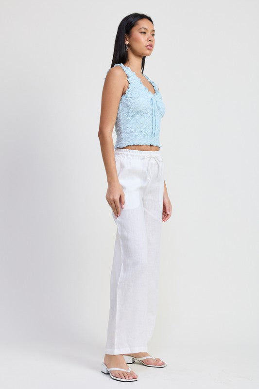 Emory Park light blue Sleeveless Ruffle Top worn with white wide-leg pants and sandals