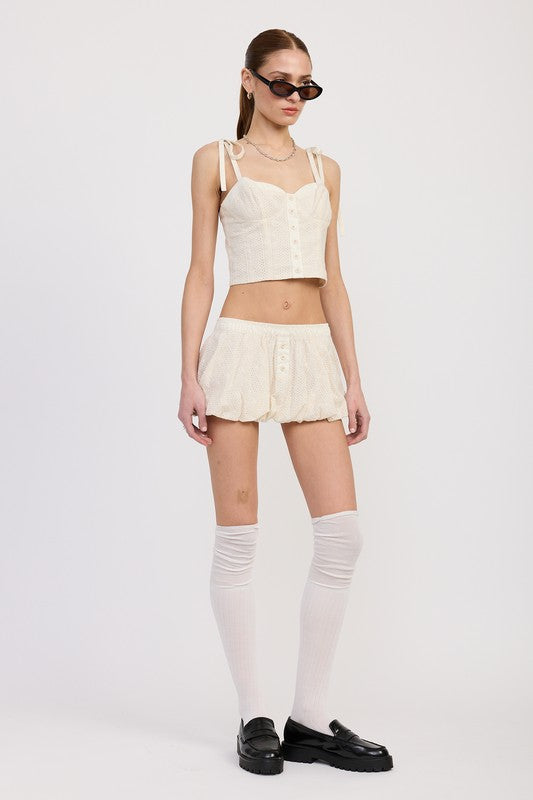 Model wearing Emory Park Bubble Mini Skirt With Elastic Waistband in cream with matching crop top and knee-high socks