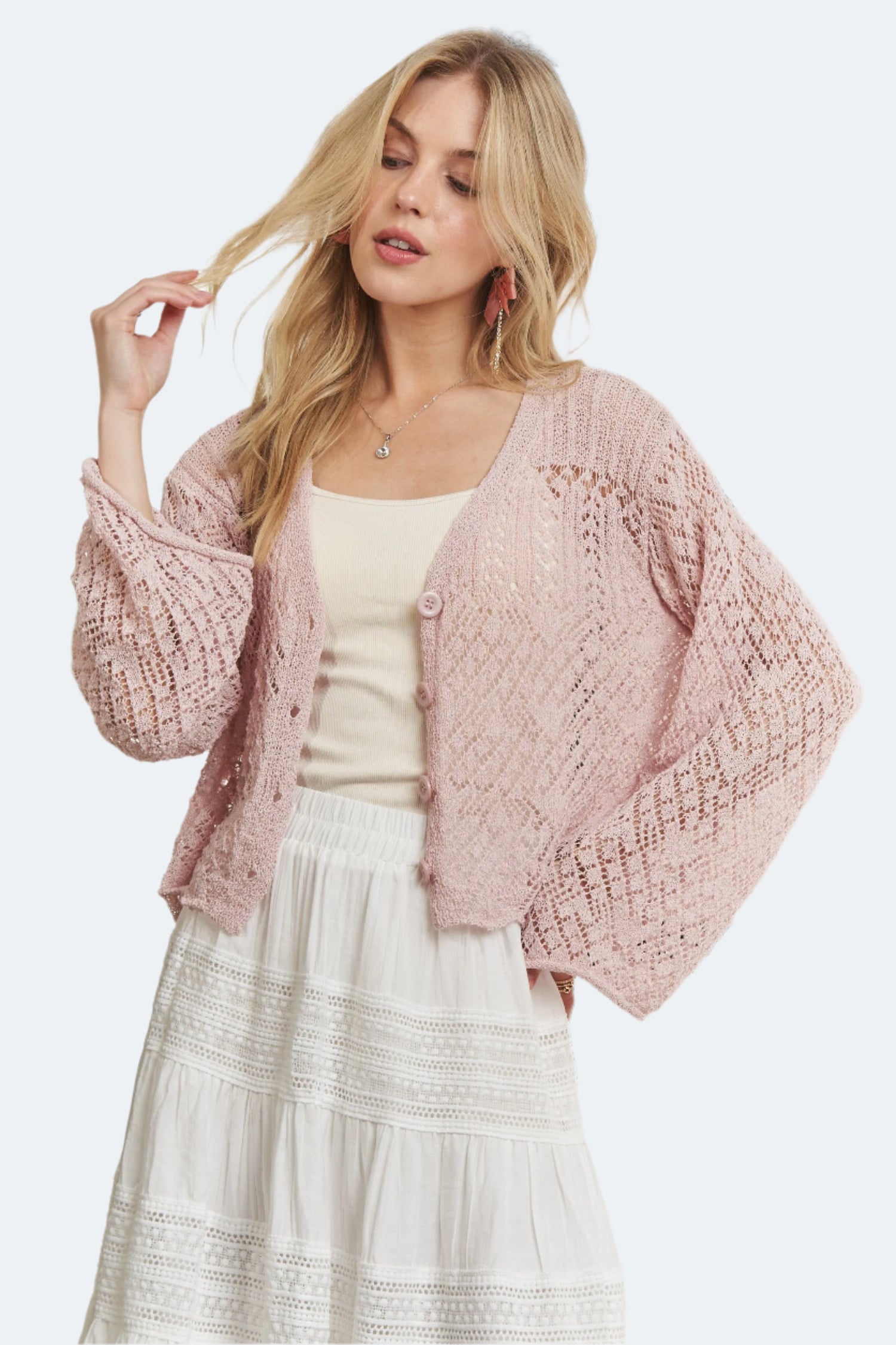 Button Knit Crochet Cardigan in soft pink with open crochet weave and relaxed fit for a casual look