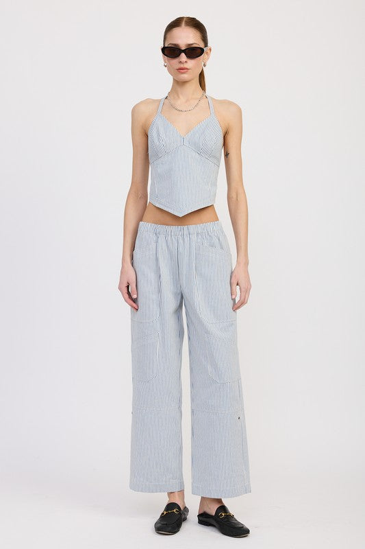 Woman wearing Emory Park Cinched Twill Pants With Wide Leg in light blue paired with a matching halter top and sunglasses