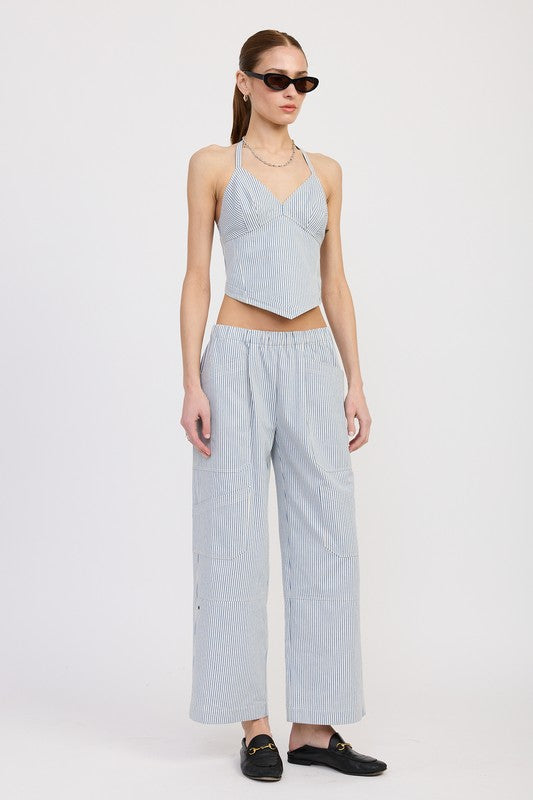 Woman wearing Emory Park Cinched Twill Pants With Wide Leg in light blue with matching halter top and black loafers