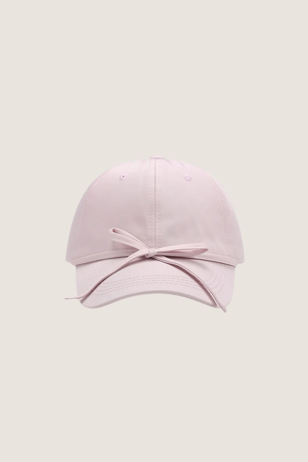 Classic cotton baseball cap in soft pink with a stylish bow detail at the front
