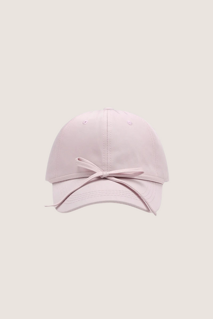 Classic cotton baseball cap in soft pink with a stylish bow detail at the front