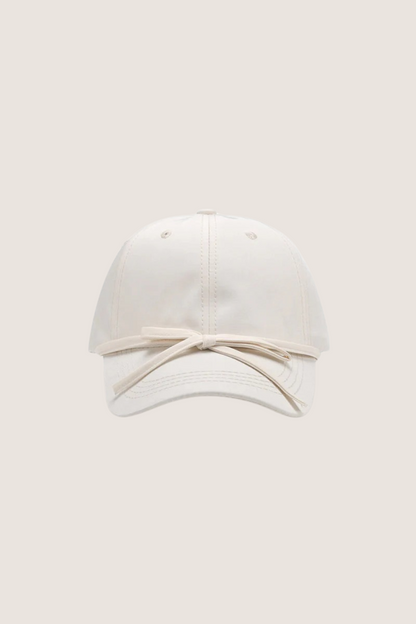 Classic cotton baseball cap in white with a stylish ribbon detail on the front