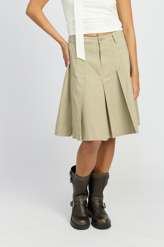 Emory Park knee length pleated skirt in beige worn with black boots and white top