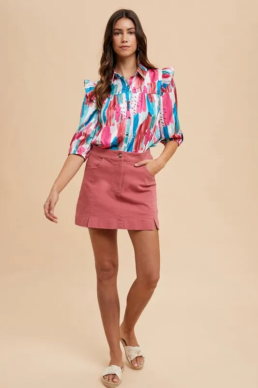Trendy model wearing a colorful blouse with a Cotton Mini Skirt in a stylish outfit