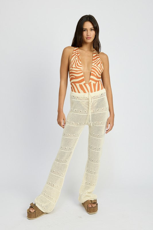 Emory Park crochet pants with drawstrings in cream worn by model with striped halter top