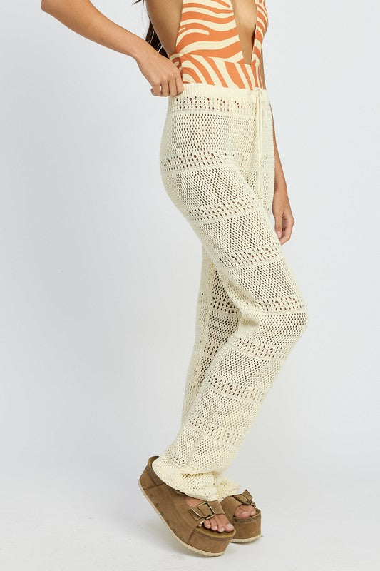 Emory Park crochet pants with drawstrings in cream worn with platform sandals and patterned top