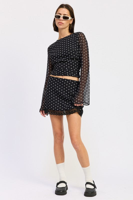 Cropped Polka Dot Sheer Top by Emory Park styled with a matching skirt and trendy accessories