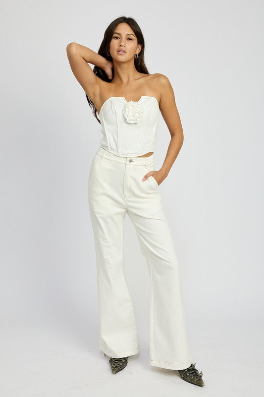 Emory Park Denim Corset Top With Rosette Detail worn by model paired with white wide-leg pants