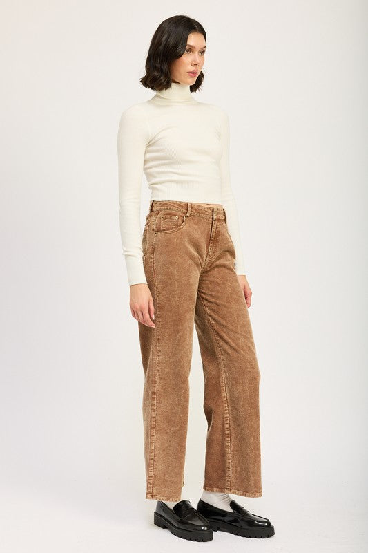 Emory Park model wearing Distressed Corduroy Pants high waisted straight leg tan brown with white turtleneck and black loafers