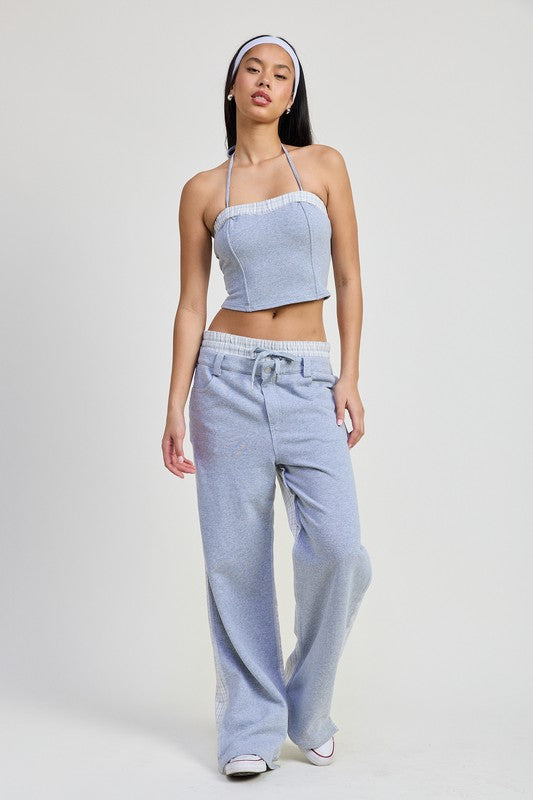 Woman wearing Emory Park Double Waist Straight Leg Pants in light blue with drawstring and matching top