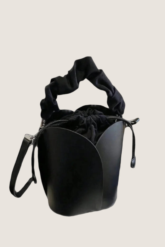 Stylish black drawstring bucket bag with a soft handle and cinched top for versatile fashion