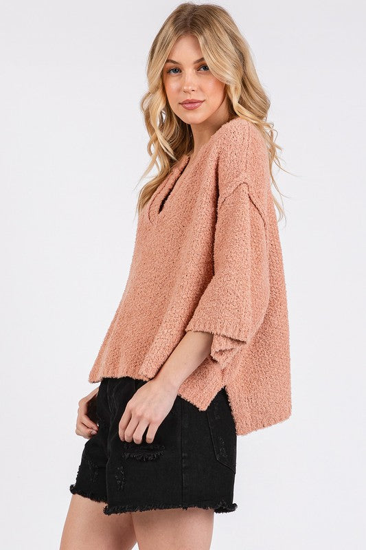 Drop Shoulder Side Slit Sweater in soft peach color paired with black denim shorts