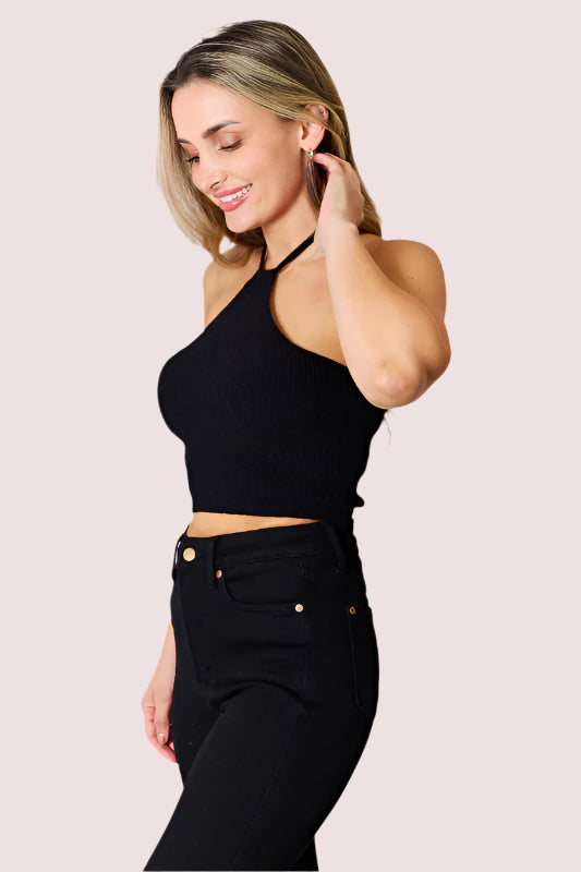 Woman wearing Elevate & Adorns Halter Neck Ribbed Cropped Knit Top in black styled with high-waisted black pants