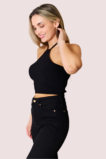 Woman wearing Elevate & Adorns Halter Neck Ribbed Cropped Knit Top in black styled with high-waisted black pants