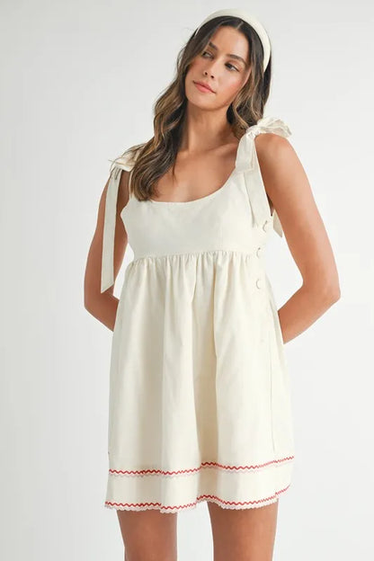Embroidered mini dress in cream with tie straps and decorative hem for summer style