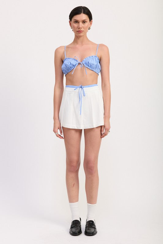 Emory Park Pleated Contrast Trim Skort in white with blue drawstring worn by model