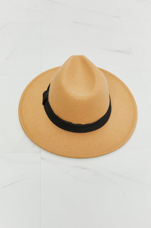 Fame You Got It Fedora Hat in tan with black band on white marble background