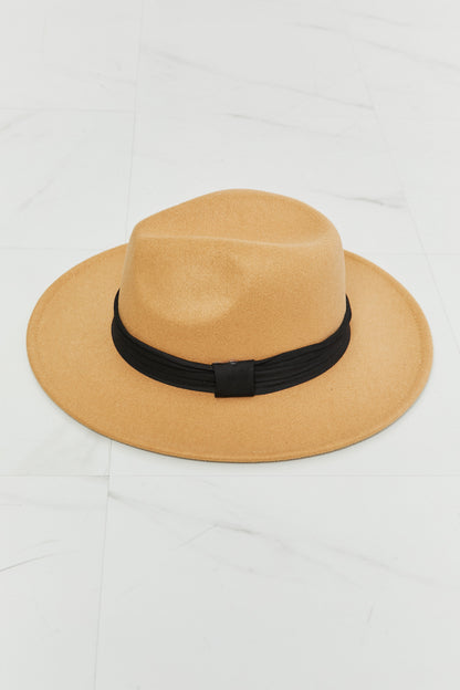 Fame You Got It Fedora Hat in tan with black ribbon band lying on white marble surface