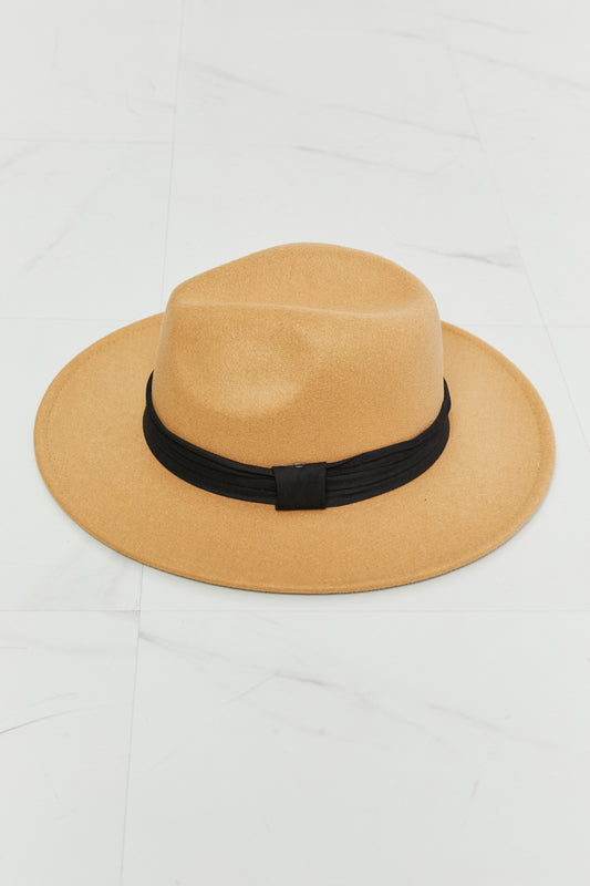 Fame You Got It Fedora Hat in tan with black ribbon band lying on white marble surface