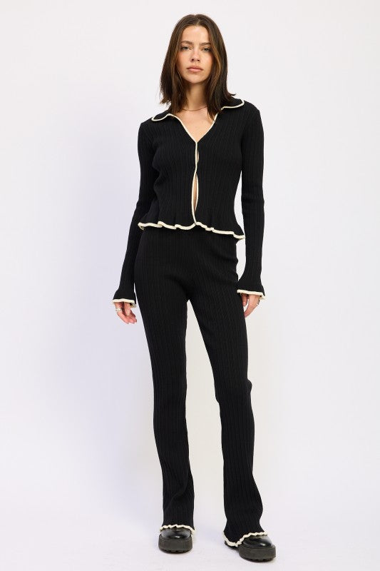 Emory Park Flared Knit Pant With Lettuce Hem in black ribbed knit worn with matching lettuce trim cardigan
