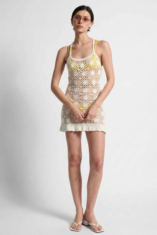 Model wearing Isla Dress in Nude Floral Crochet Open-Knit Beach Cover-Up over bikini with heeled sandals on a plain background