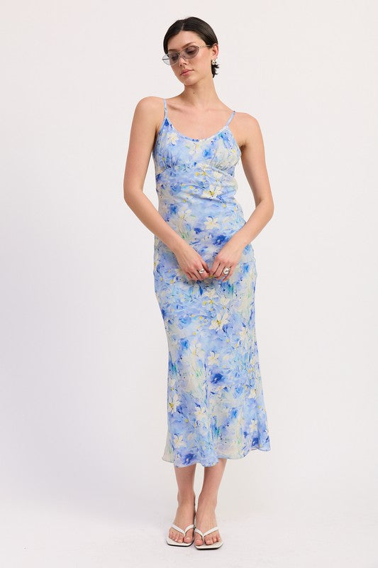 Emory Park Floral Satin Slip Midi Dress in blue and yellow floral print worn with white sandals and sunglasses