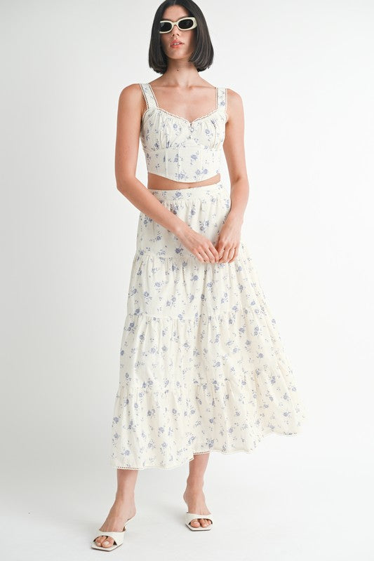 Emory Park Floral Tiered Maxi Skirt in white with blue floral print worn with matching crop top and white sandals