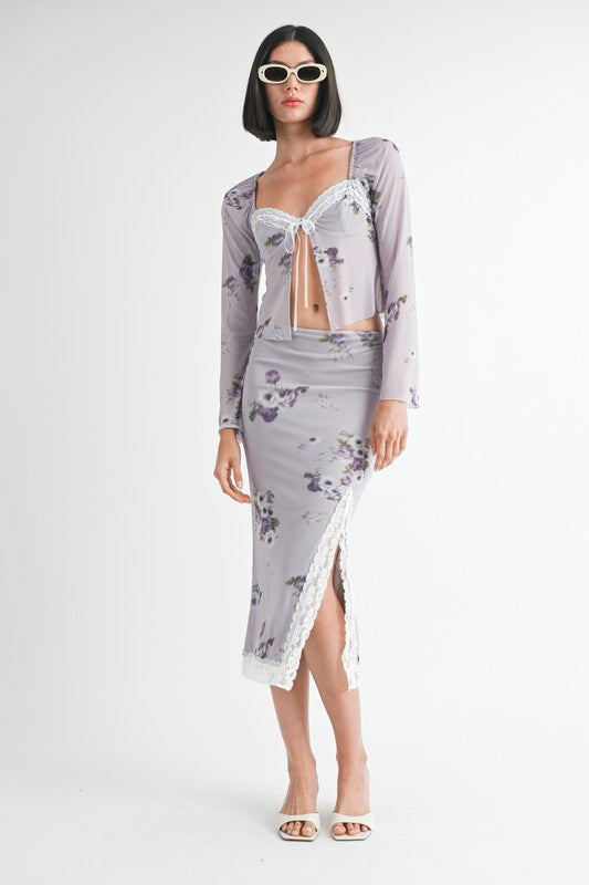 Woman wearing Emory Park Fly Away Floral Top With Lace in lavender with matching skirt and white sunglasses