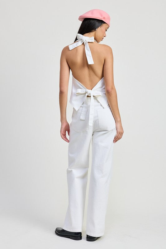 Emory Park model wearing Folded Fitted Denim Pants in white with a backless top and pink beret