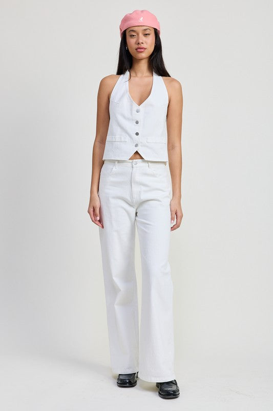 Emory Park model wearing folded fitted denim pants in white with a sleeveless vest and pink cap
