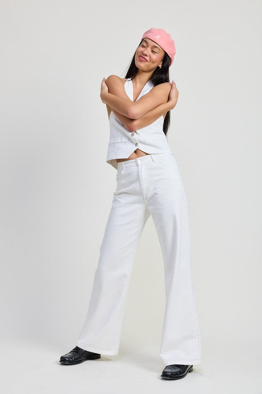 Woman wearing Emory Park Folded Fitted Denim Pants in white with a sleeveless top and pink beret