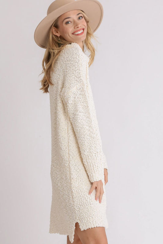 High-low boucle sweater dress in cream with a relaxed fit and side slits for a stylish look