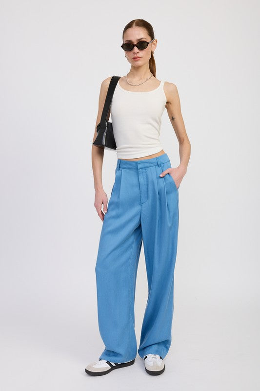 Emory Park High Waist Wide Leg Trousers With Front Pleats in blue worn with white tank and black sunglasses
