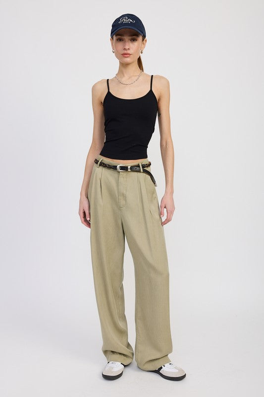Emory Park High Waist Wide Leg Trousers With Front Pleats in beige worn with black tank top and cap