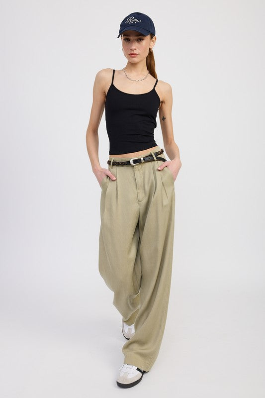 Emory Park High Waist Wide Leg Trousers With Front Pleats in beige worn with black tank top and cap pose