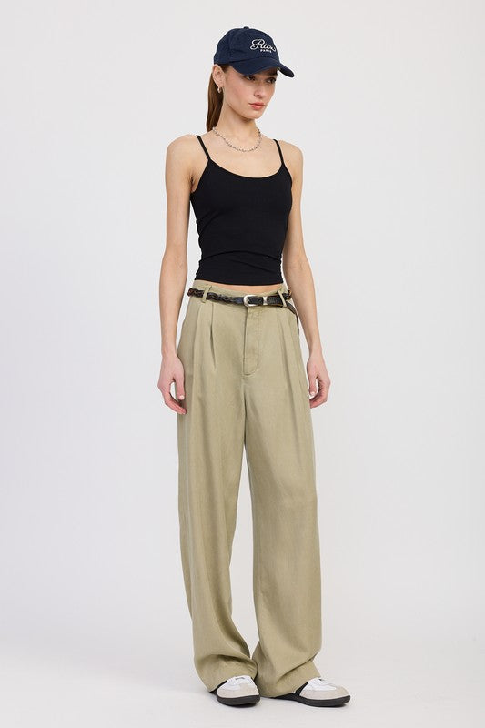 Emory Park High Waist Wide Leg Trousers With Front Pleats in beige worn with black tank and navy cap