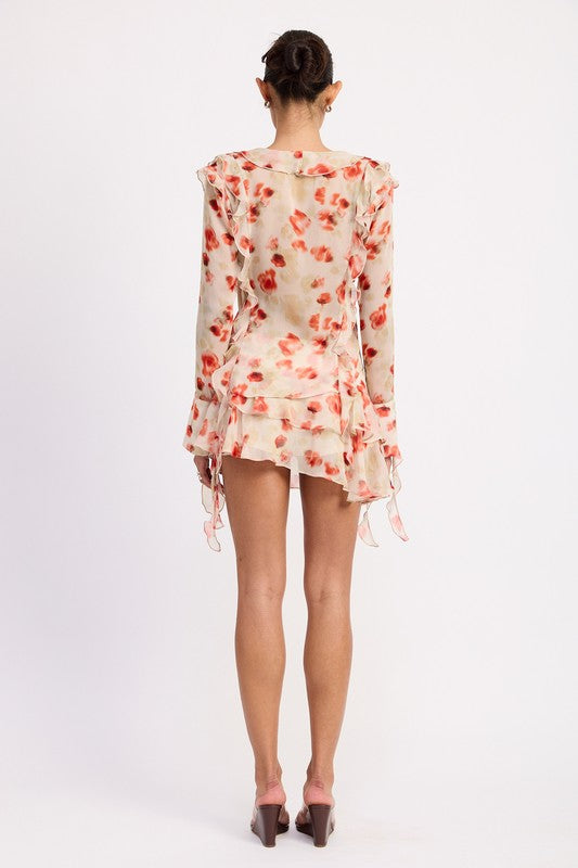 Back view of model wearing Emory Park Layered Ruffle Mini Skirt in cream floral with sheer ruffled long sleeve top